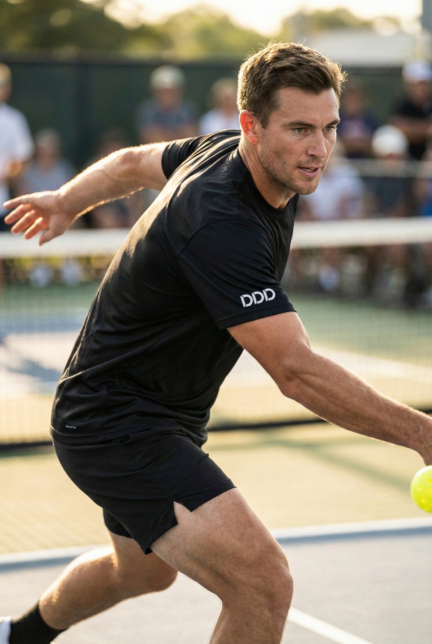 Man playing pickleball on a court with a blurred background